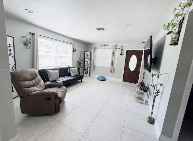 tiled living room featuring a textured ceiling