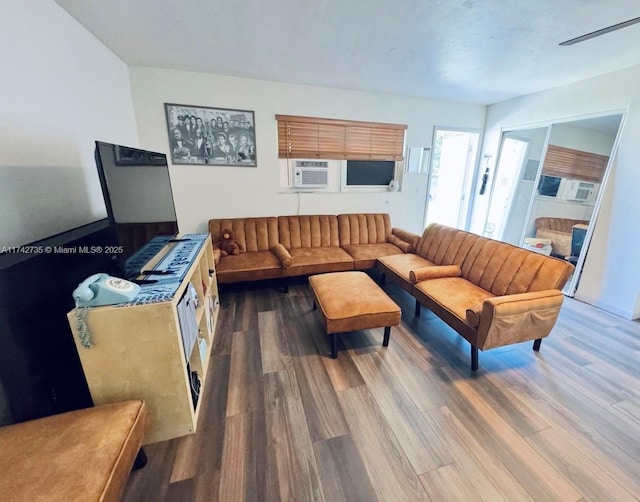 living room with cooling unit and hardwood / wood-style floors