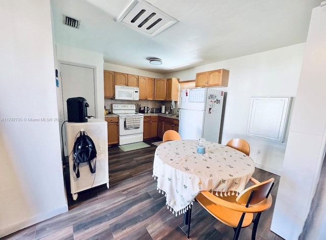 kitchen featuring tasteful backsplash, white appliances, and dark hardwood / wood-style floors