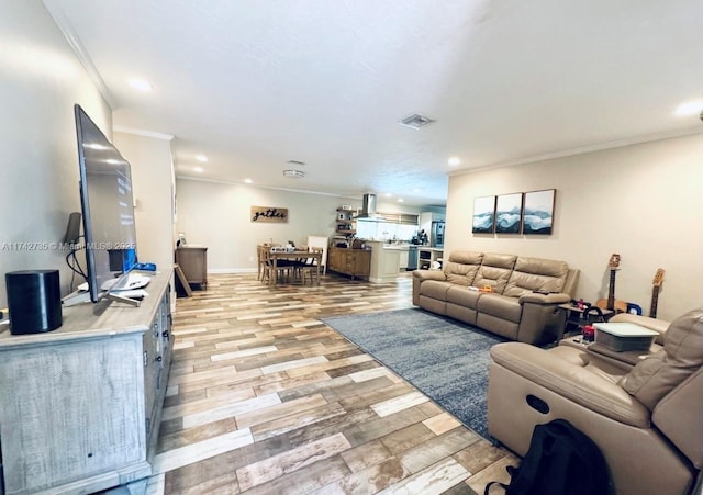 living room with ornamental molding and light wood-type flooring