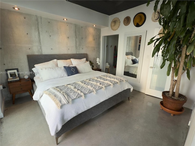 bedroom featuring concrete flooring