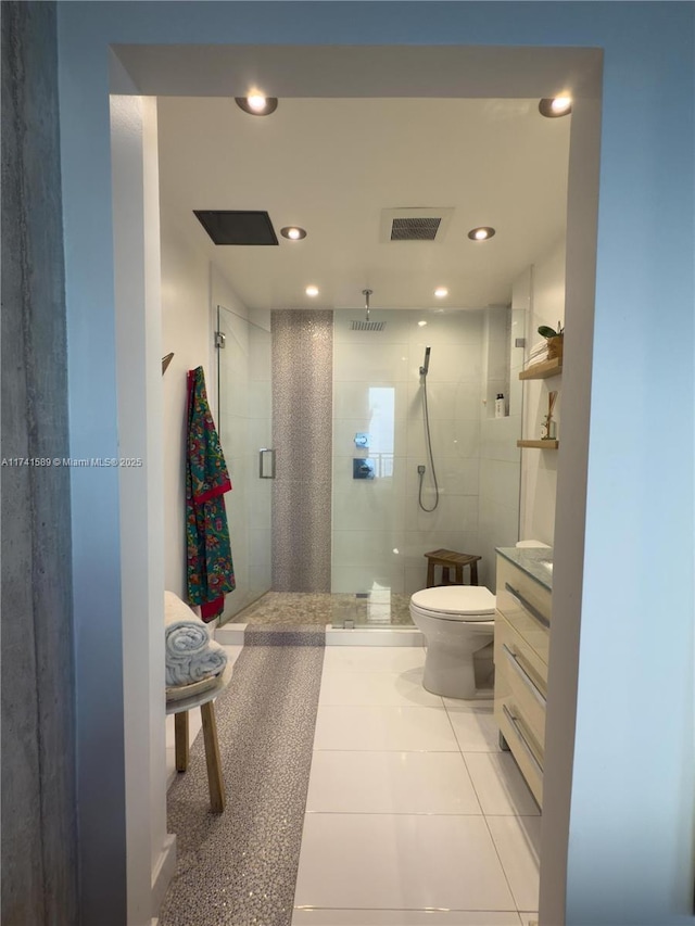 bathroom with vanity, toilet, an enclosed shower, and tile patterned flooring