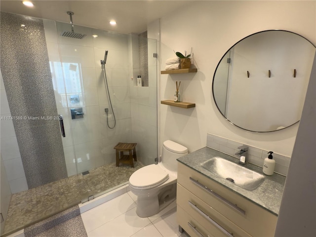 bathroom with tile patterned flooring, vanity, an enclosed shower, and toilet