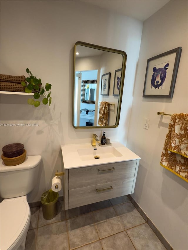 bathroom with vanity, toilet, and tile patterned flooring