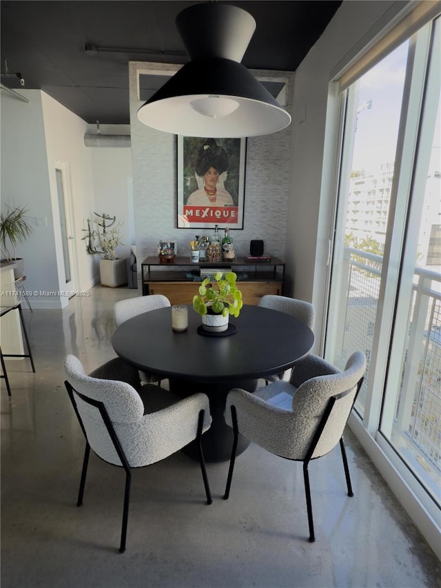 dining space featuring concrete flooring