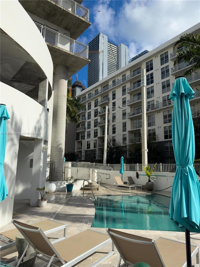 view of swimming pool featuring a patio area