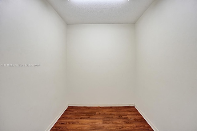 spare room with wood-type flooring and a textured ceiling