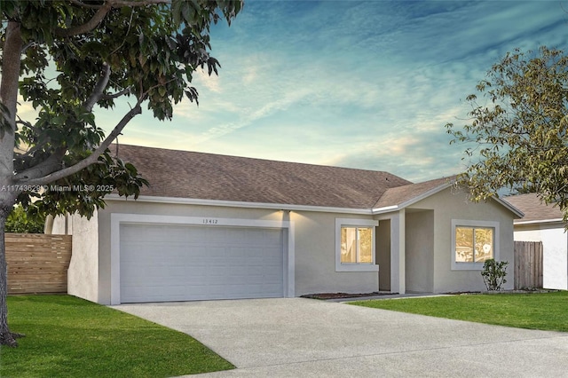 ranch-style home with concrete driveway, fence, an attached garage, and stucco siding