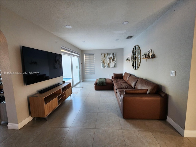 tiled living room with a textured ceiling