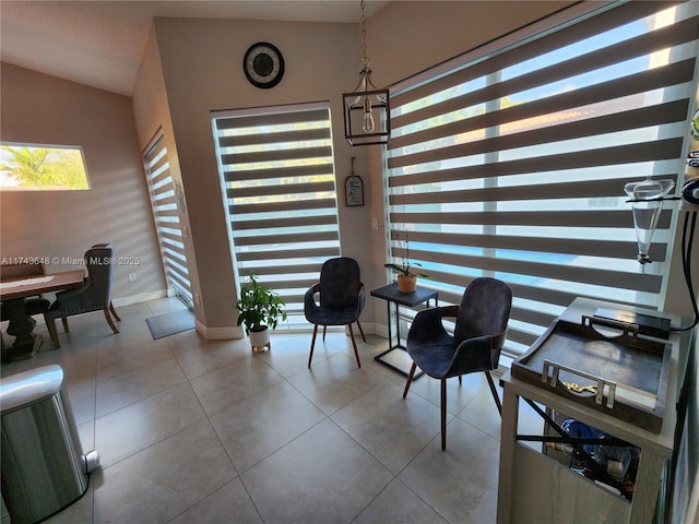 living area with vaulted ceiling and light tile patterned floors