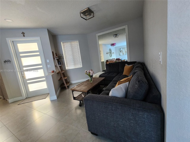 tiled living room featuring a textured ceiling