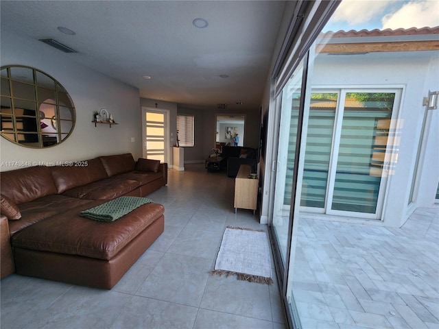 tiled living room featuring plenty of natural light