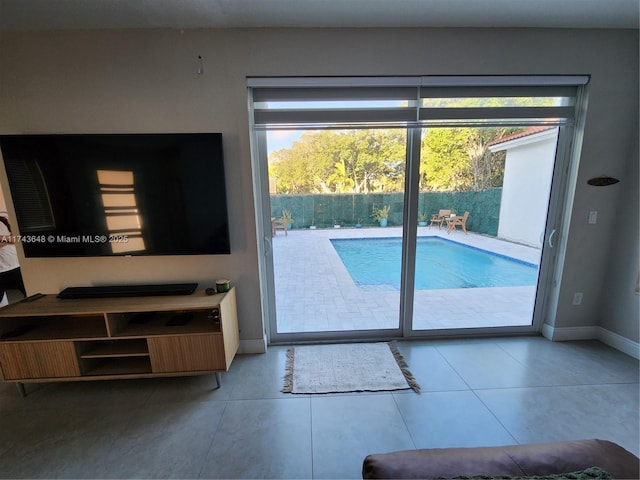 doorway to outside featuring light tile patterned flooring