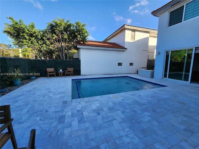 view of swimming pool with a patio area