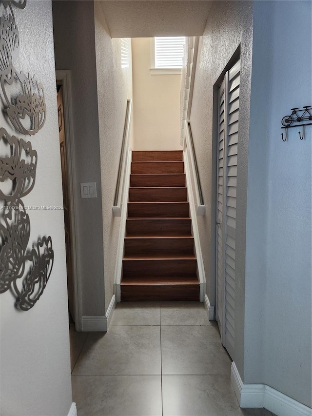 stairway with tile patterned flooring