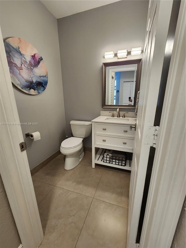 bathroom featuring vanity, tile patterned floors, and toilet