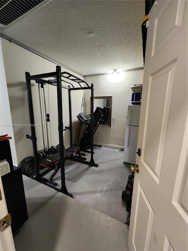 exercise area with a textured ceiling