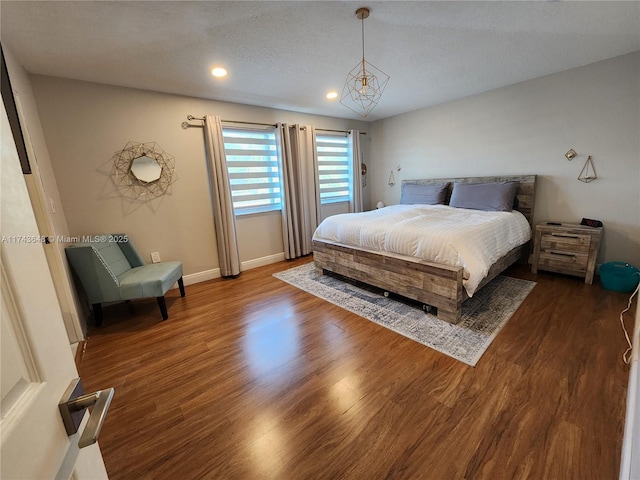 bedroom featuring dark hardwood / wood-style floors and a textured ceiling