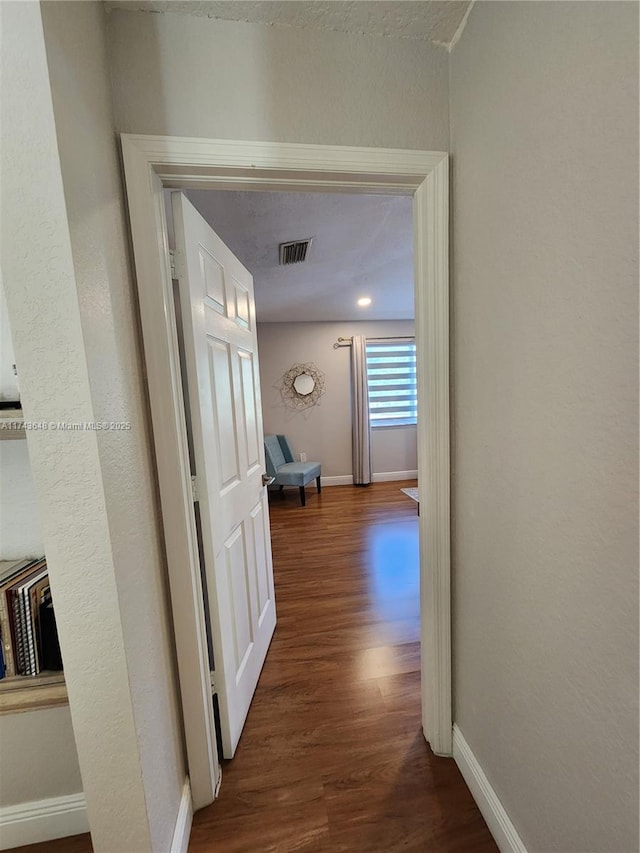 hallway featuring dark wood-type flooring