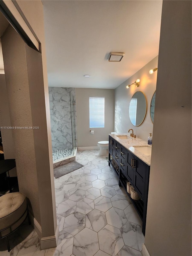 bathroom with a tile shower and vanity