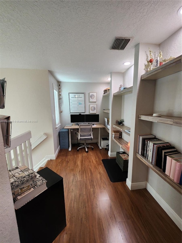 office featuring wood-type flooring and a textured ceiling