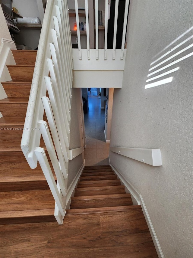 stairs featuring hardwood / wood-style flooring