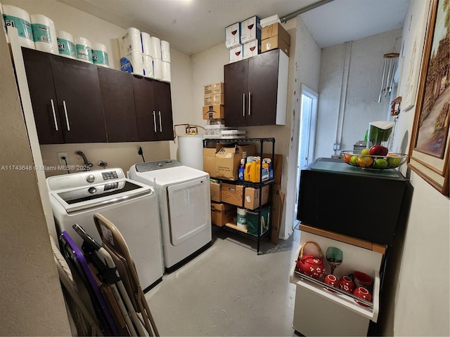 washroom with cabinets and washer and dryer