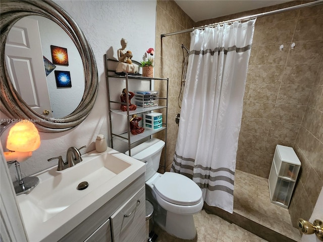 bathroom featuring walk in shower, tile patterned floors, vanity, and toilet