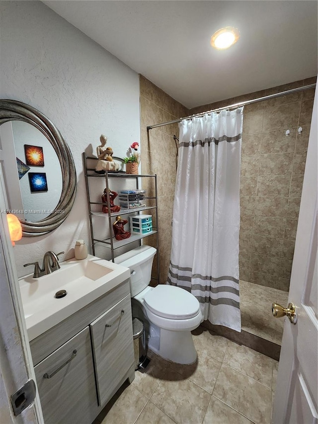 bathroom featuring tile patterned flooring, vanity, toilet, and a shower with shower curtain