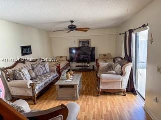 living room with ceiling fan and light wood-type flooring