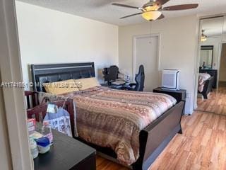 bedroom featuring ceiling fan and light hardwood / wood-style floors