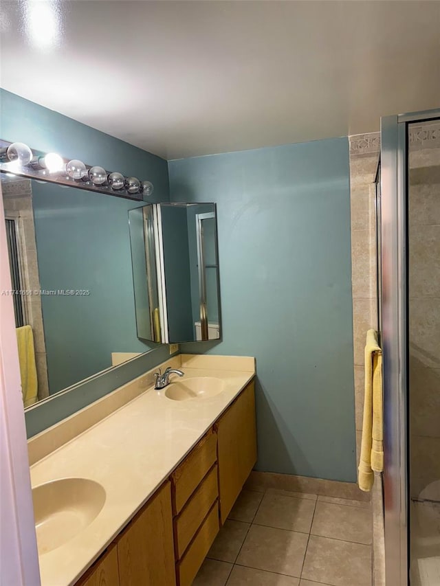 bathroom featuring vanity, a shower with shower door, and tile patterned flooring