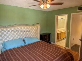 bedroom featuring ceiling fan and ensuite bathroom