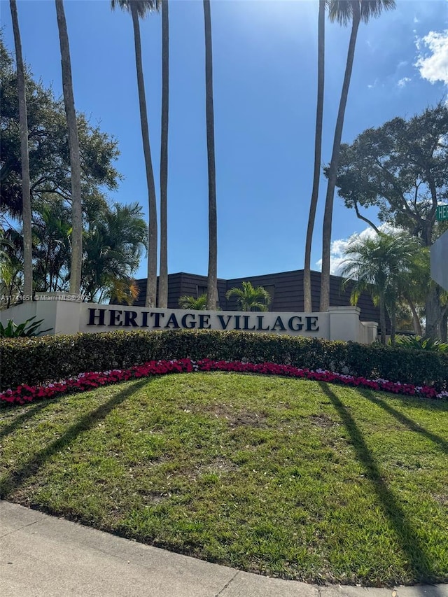 community / neighborhood sign with a lawn