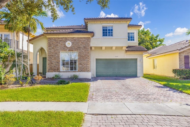 mediterranean / spanish-style home featuring a front yard and a garage