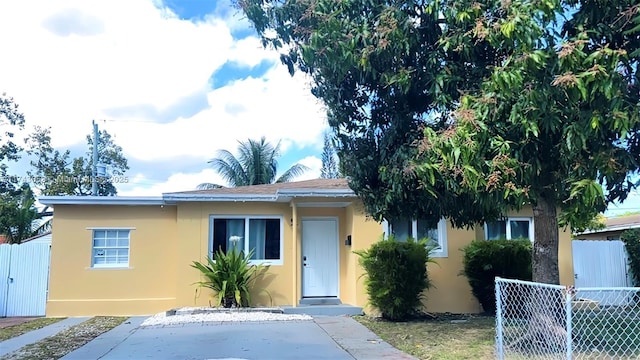 view of front of home with fence and stucco siding