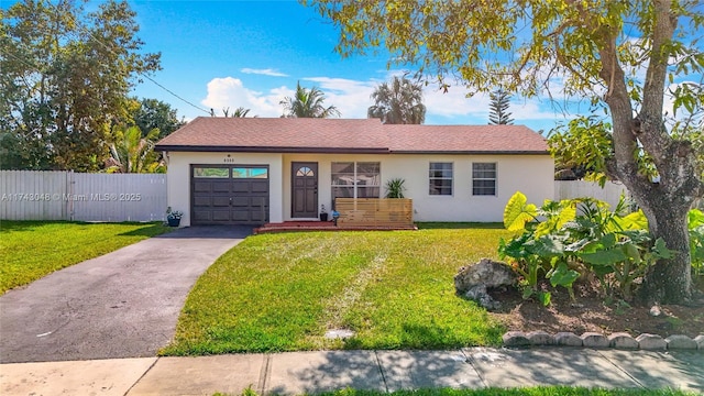 single story home with a garage, stucco siding, a front yard, fence, and concrete driveway