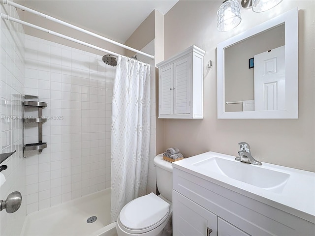 full bathroom with vanity, a stall shower, and toilet
