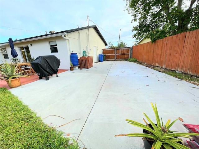exterior space with a patio area, stucco siding, and fence