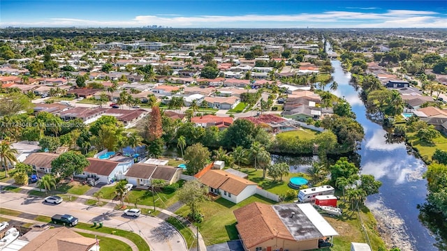 drone / aerial view with a water view and a residential view