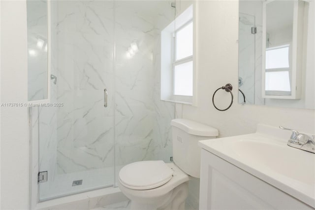 bathroom featuring vanity, an enclosed shower, and toilet