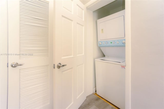 washroom featuring stacked washer and clothes dryer