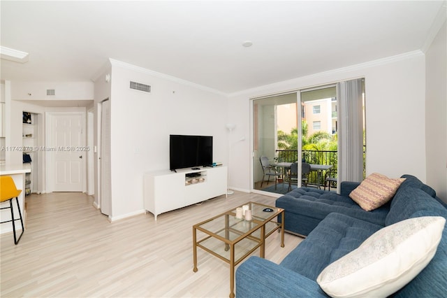 living room with ornamental molding and light hardwood / wood-style flooring