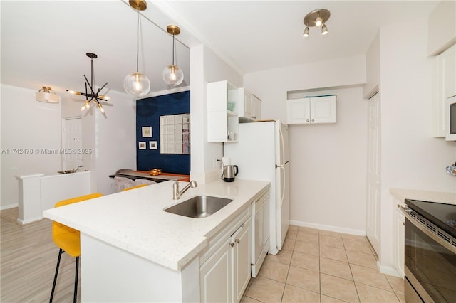 kitchen featuring white cabinetry, dishwasher, sink, and stainless steel electric range