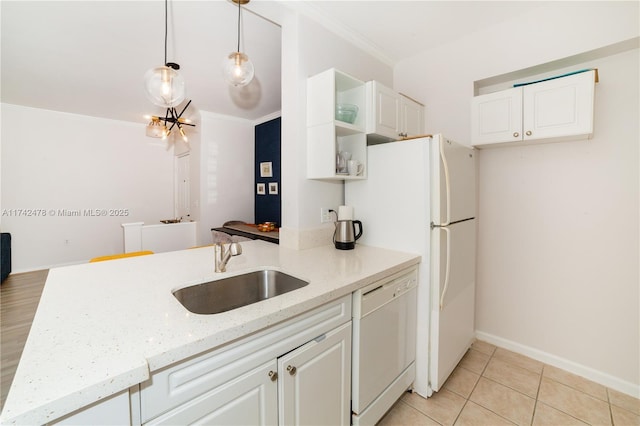 kitchen featuring white cabinetry, white appliances, decorative light fixtures, and sink