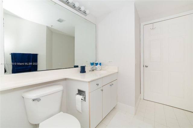 bathroom featuring tile patterned flooring, vanity, and toilet