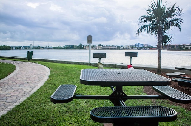 view of community with a water view and a lawn