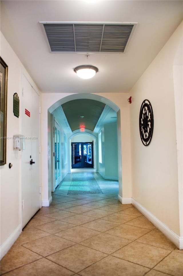 corridor with light tile patterned floors