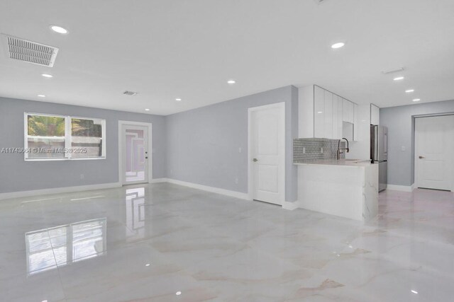 unfurnished living room with sink