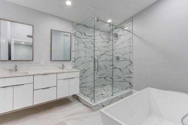 bathroom featuring vanity and shower with separate bathtub